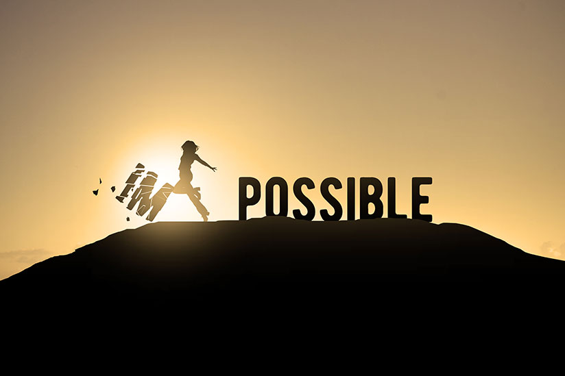 A two dimensional image of the word “impossible” on top of a hill. The letters I and M are being kicked away by a person seen only as a black silhouette, revealing the letters that are left, which spell out “possible”.